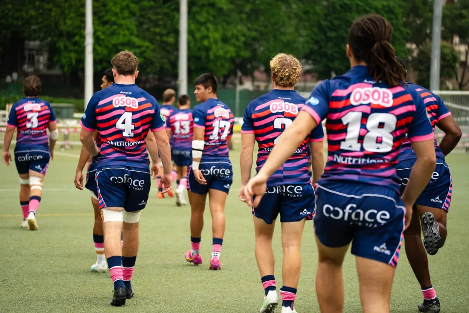 OSOB players in navy chase the ball in open play