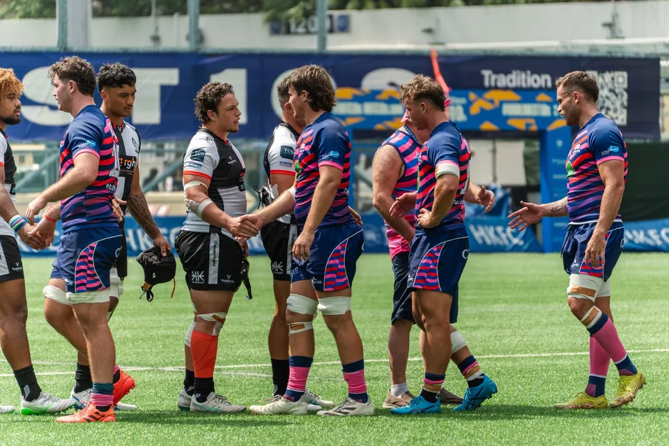 OSOB players shake hands with the opposition after a match
