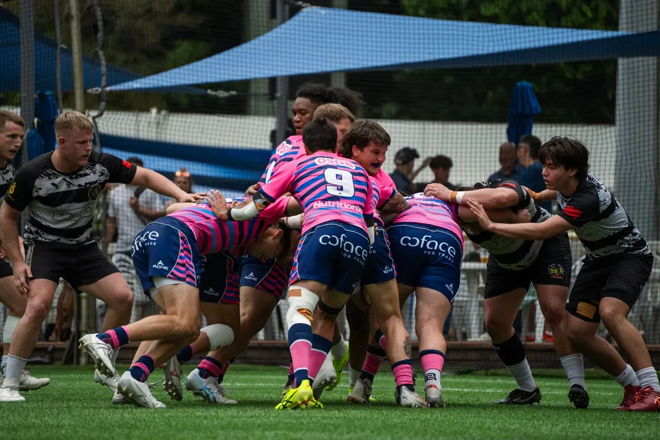 OSOB players in pink drive a maul