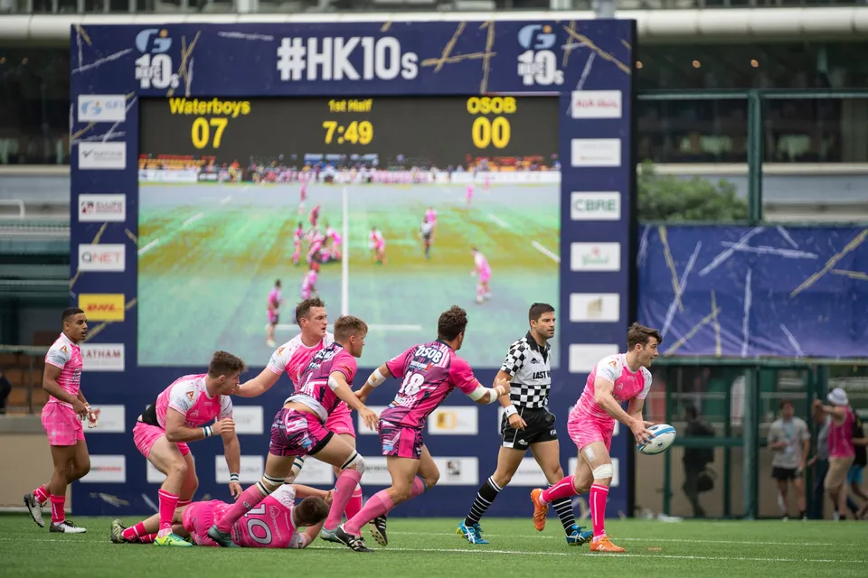 OSOB scrum-half passes from a ruck beneath the HK10s scoreboard in the first half against Projecx Waterboys