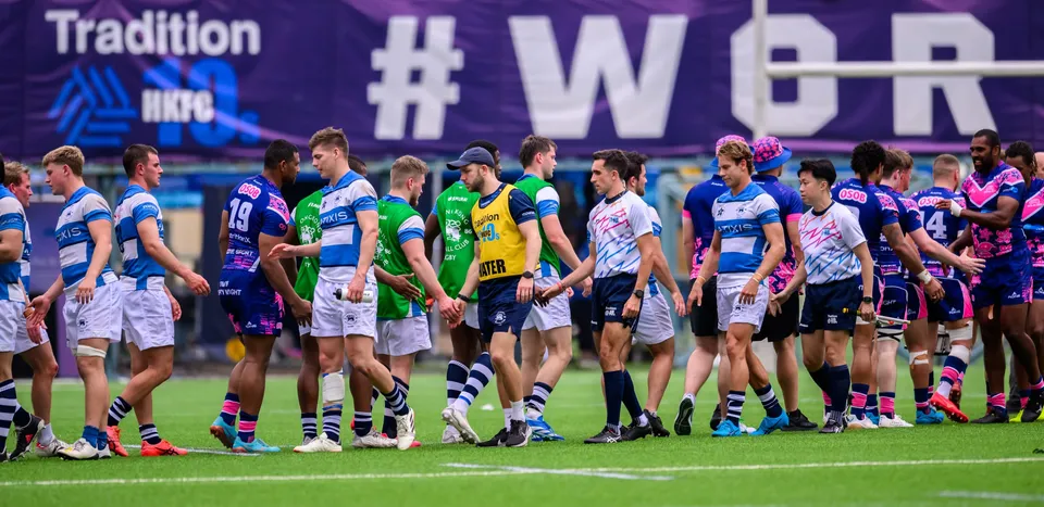 Players from both teams shake hands in a line on the pitch after OSOB's match with HKFC Natixis Club, 2024