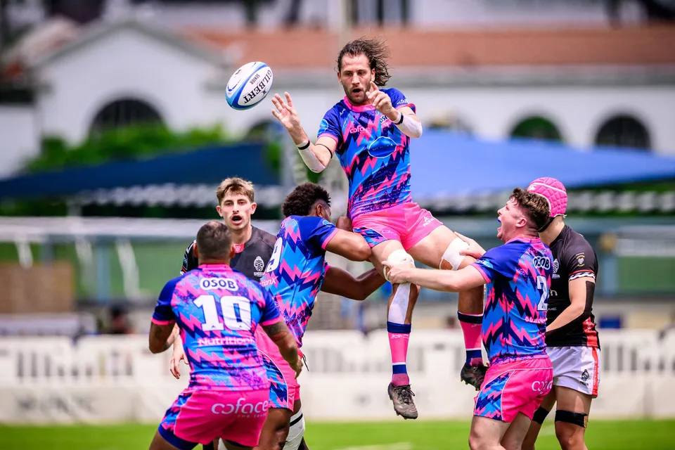 OSOB jumper catches the ball high above supporting team-mates at a line-out, with number 10 in the foreground