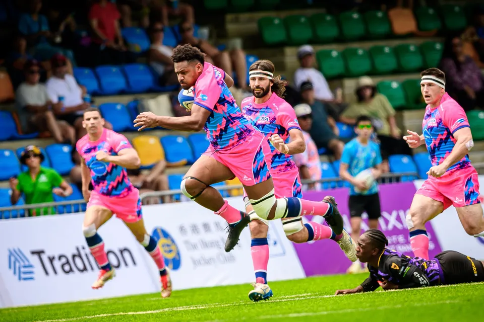 OSOB ball carrier bursts forward with two teammates in support against Tens Selects, a purple player sprawled behind