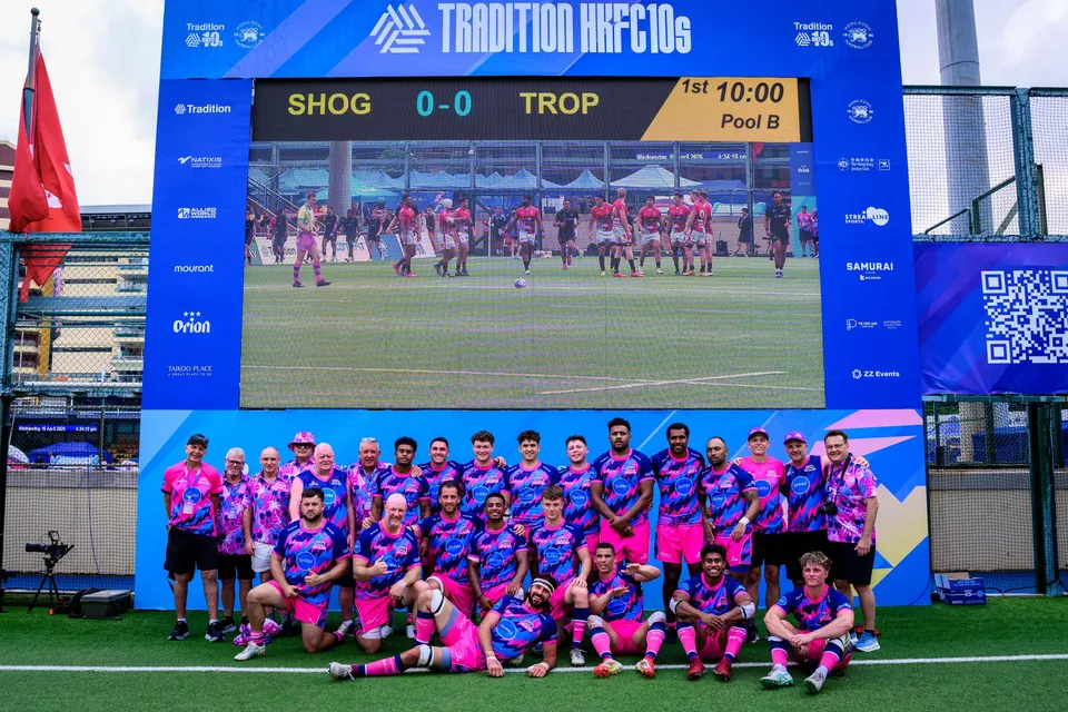 OSOB squad in pink and blue pose below a screen showing SHOG against TROP at 0-0, Pool B, 2026 HKFC 10s