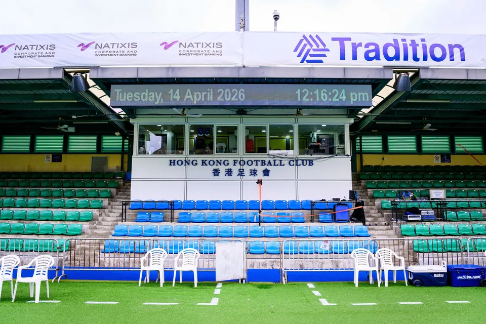 Hong Kong Football Club pavilion with a digital date clock, Natixis and Tradition banners and white chairs