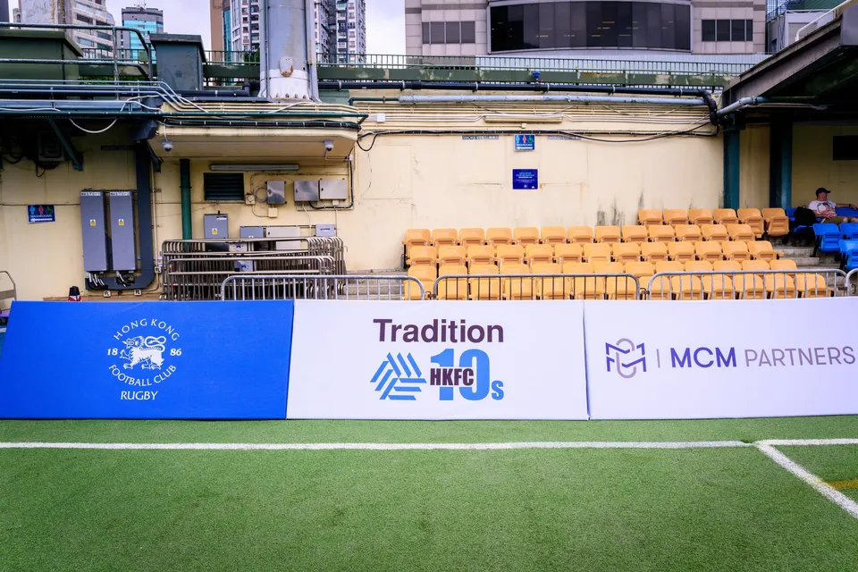 Boards for HKFC Rugby, Tradition HKFC 10s and MCM Partners in front of orange stand seats