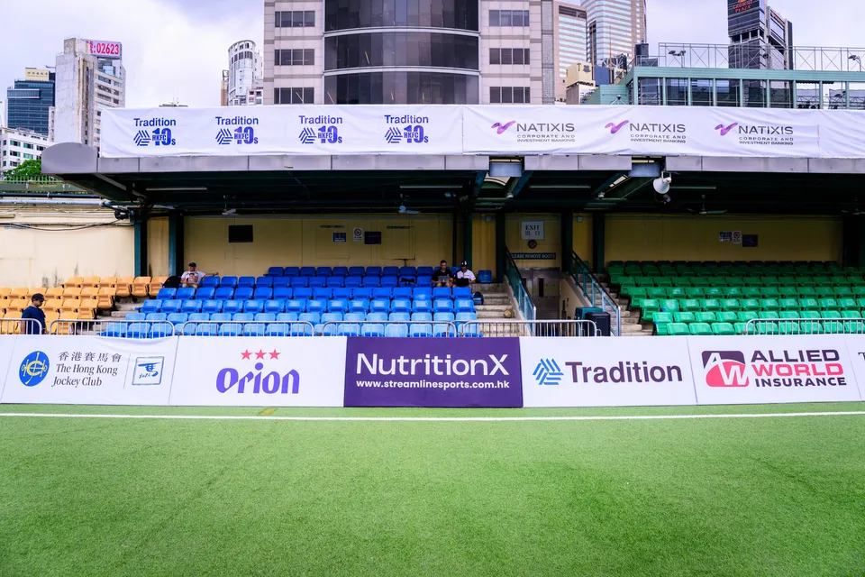 Stand with blue and green seats behind Orion, NutritionX, Tradition and Allied World Insurance boards